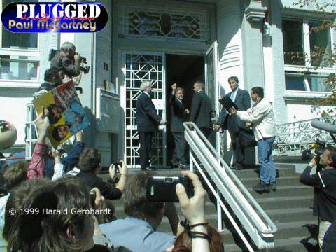 Paul waiving before he enters the building